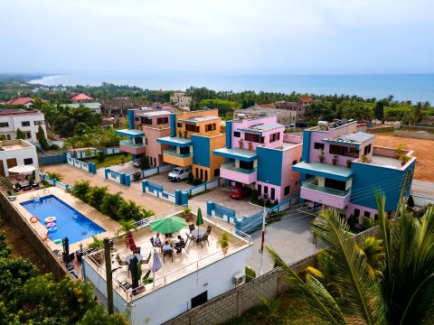 Aerial view of the PQ residence in Kokrobite with the pool, rooftop terrace and the Atlantic coast behind