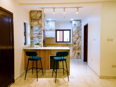 Brown apartment kitchen with breakfast bar and stools