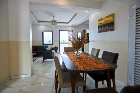 Pink apartment dining table with the living room behind