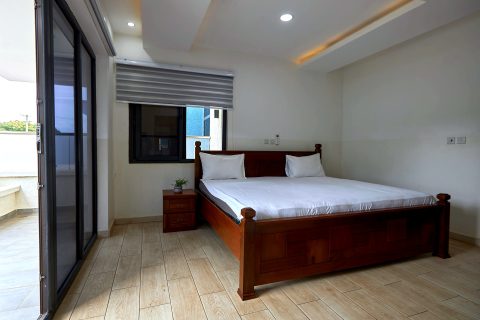 Pink apartment bedroom with sliding doors to a balcony