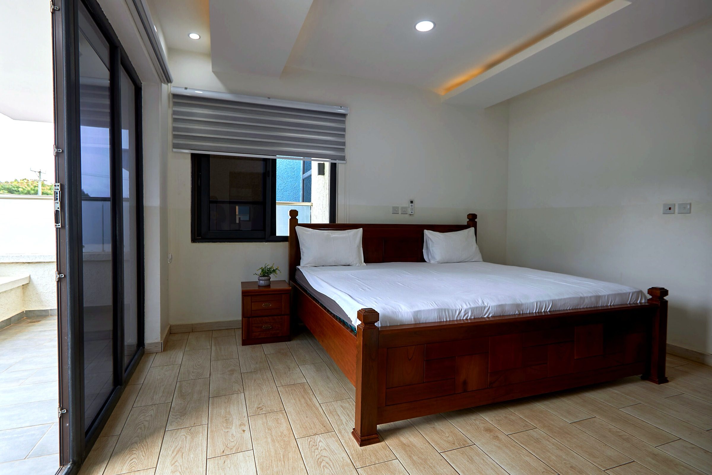 Pink apartment bedroom with sliding doors to a balcony