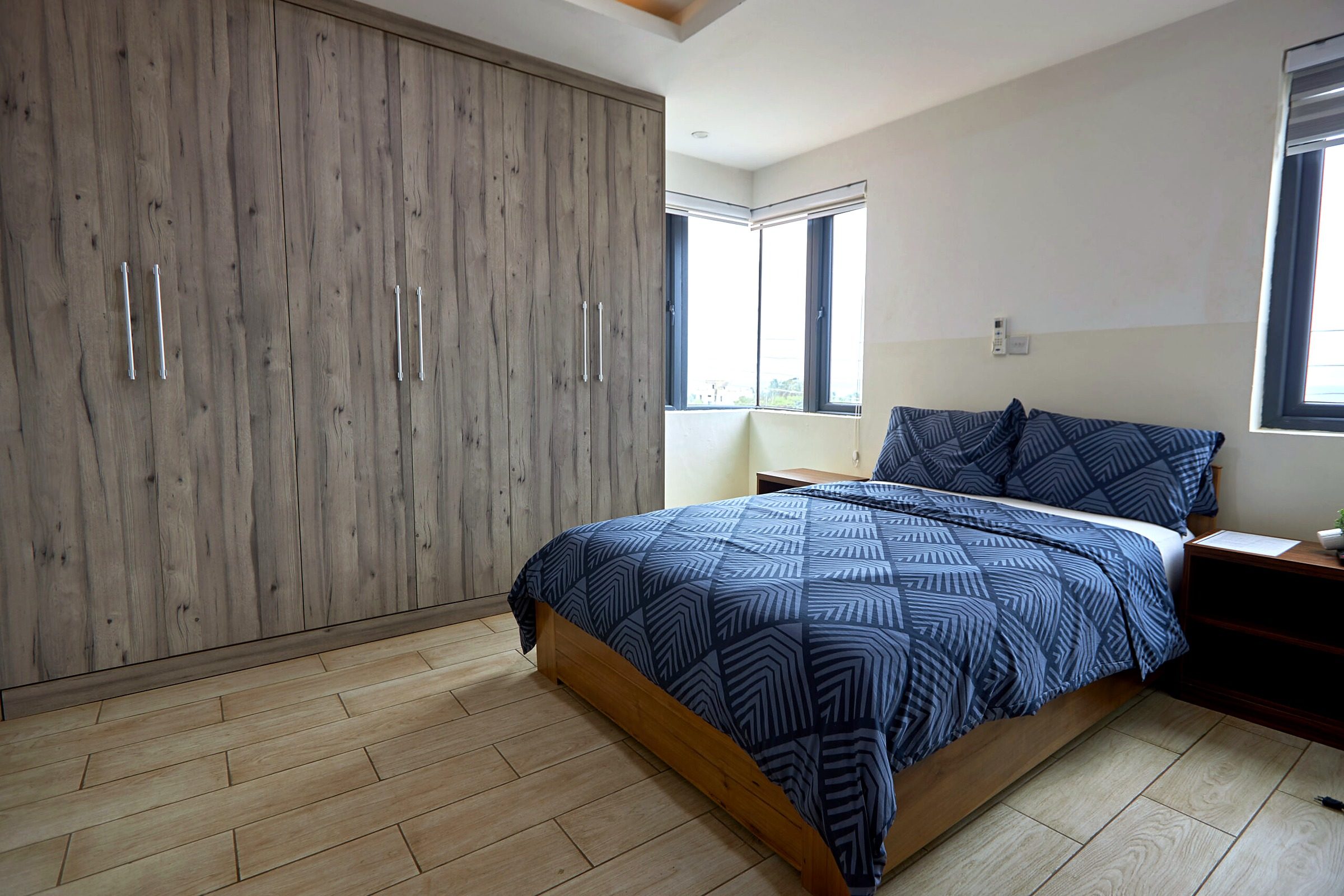Pink apartment bedroom with a double bed and fitted wardrobe