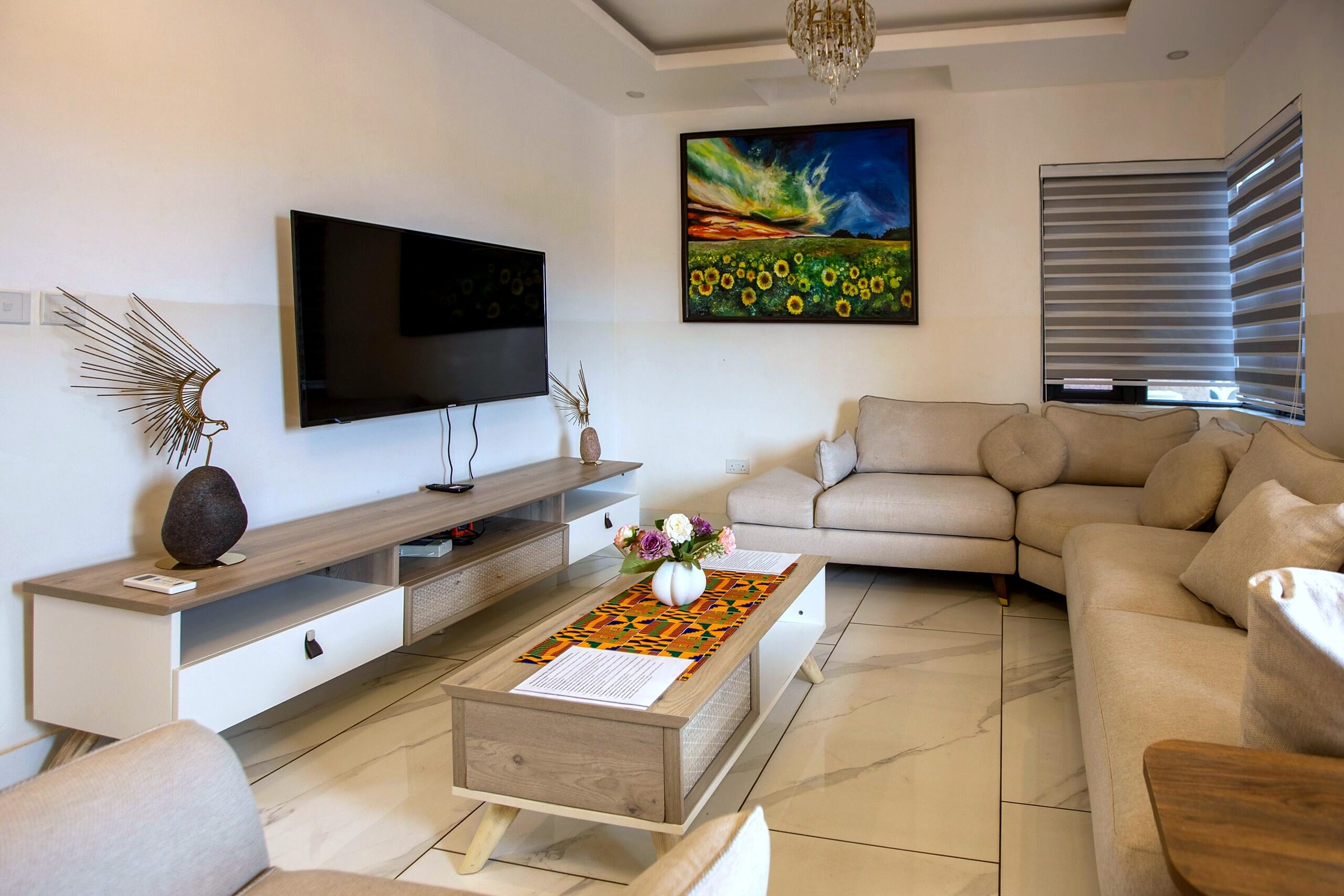 Orange apartment living room with a corner sofa and TV unit